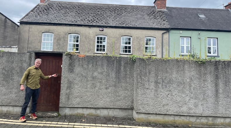 The author at the gate of Peters Cell, the ancient home in Limerick that has been home to his family for 150 years. Courtesy of Julie Hodack