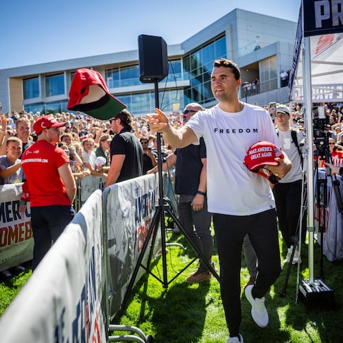 FILE - Charlie Kirk hands out hats before speaking at Utah Valley University in Orem, Utah, Sept. 10, 2025. (Tess Crowley/The Deseret News via AP, File)