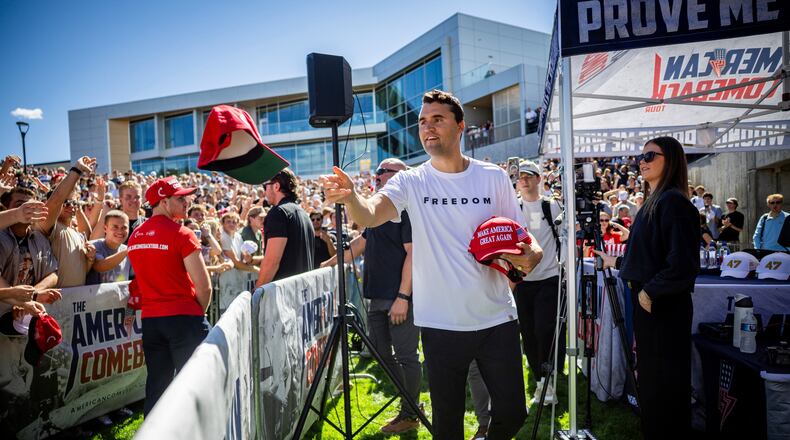 FILE - Charlie Kirk hands out hats before speaking at Utah Valley University in Orem, Utah, Sept. 10, 2025. (Tess Crowley/The Deseret News via AP, File)