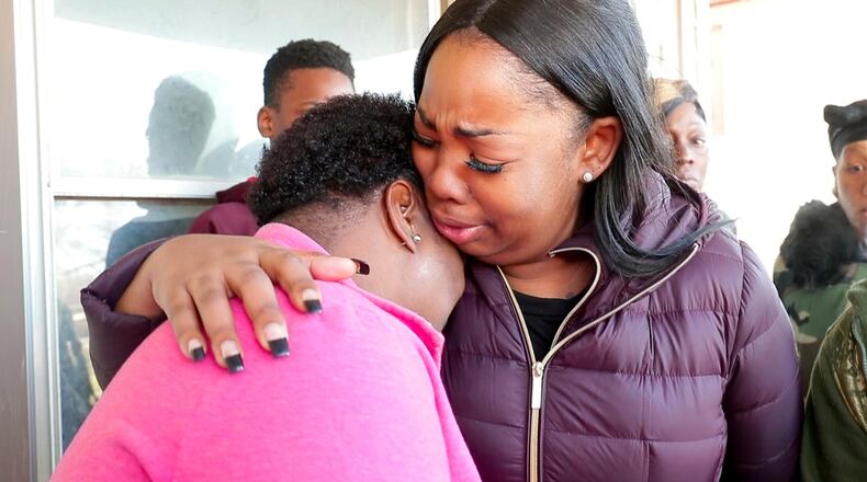 Bernice Parks, left, is consoled by Jasmine Wells, the godmother of Parks' daughter Sandra, who was shot to death Monday in Milwaukee.