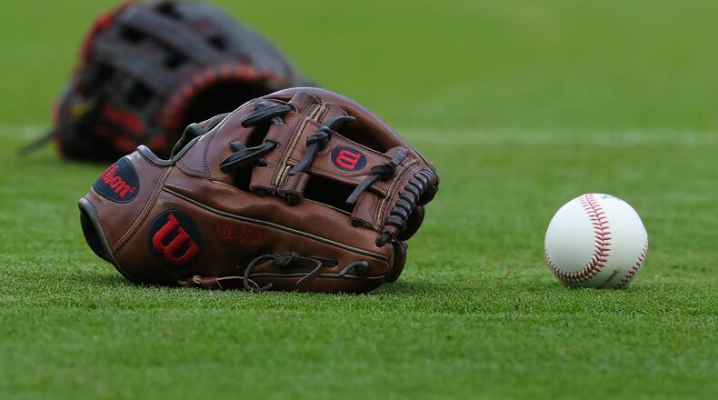 042821 Atlanta: Atlanta Braves shortstop Dansby Swanson’s glove and ball sit on the field while preparing to play the Chicago Cubs in a MLB baseball game on Wednesday, April 28, 2021, in Atlanta.    “Curtis Compton / Curtis.Compton@ajc.com”