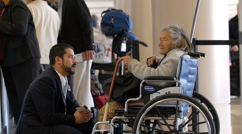 Delta Airlines Lead Agent Jorge Herrera talks Jan. 28, 2008, with passenger Cealia Marquez after she arrived at Los Angeles International Airport on a Delta flight from Mexico.
