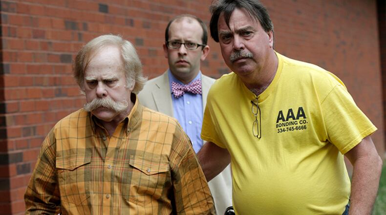 Harvey Updyke, left, leaves the Lee County Justice Center in Opelika, Ala., with his bail bondsman and his attorney on June 10, 2013.