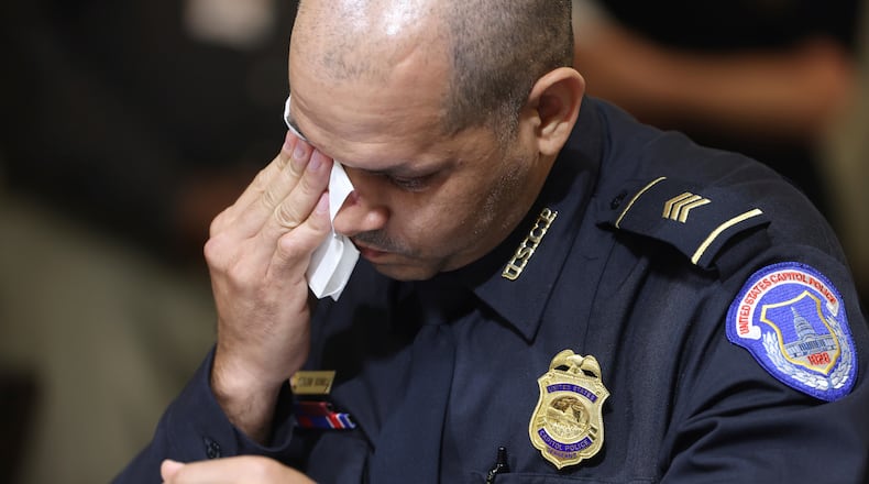 FILE - U.S. Capitol Police Sgt. Aquilino Gonell wipes his eye as he watches a video being displayed during a House select committee hearing on the Jan. 6 attack on Capitol Hill in Washington, July 27, 2021. (Jim Lo Scalzo/Pool via AP, File)