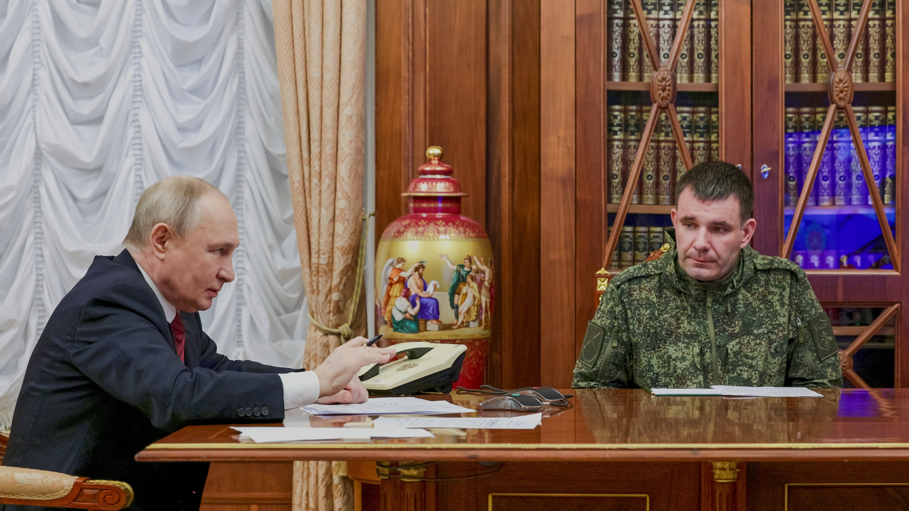 Russian President Vladimir Putin, left, holds a call with military leaders on the Ukraine battlefield situation together with Denis Pirogov, right, a Russian army brigade commander, at the Kremlin in Moscow, on Thursday, Dec. 11, 2025. (Gavriil Grigorov, Sputnik, Kremlin Pool Photo via AP)