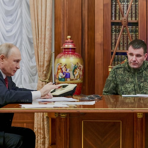 Russian President Vladimir Putin, left, holds a call with military leaders on the Ukraine battlefield situation together with Denis Pirogov, right, a Russian army brigade commander, at the Kremlin in Moscow, on Thursday, Dec. 11, 2025. (Gavriil Grigorov, Sputnik, Kremlin Pool Photo via AP)