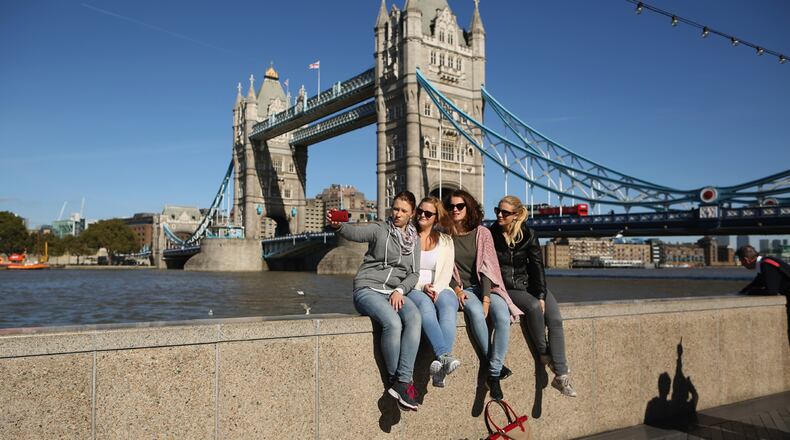 A group of girls take a 'selfie' in front of Tower Bridge on September 28, 2015 in London, England. Warm weather is set to continue with temperatures predicted to reach 22 degrees in the South of the country. (Photo by Dan Kitwood/Getty Images)