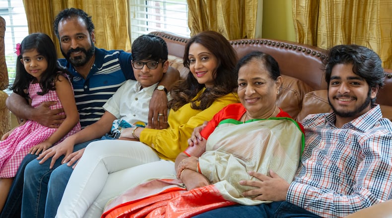 Westminster School senior Azeez Ishaqui (right) poses with his family (from right to left), his grandmother Najma, mother Huma, brother Baseer, father Syed and sister Maha in their Smyrna home. During the pandemic Azeez came up with an idea to have women from India sew face masks that he would donate to homeless shelters in metro Atlanta. HIs grandmother helped him accomplish that with her connections there. He was a high school freshman when he started helping the poor in India, first providing carts for men selling goods, and then later providing sewing machines for widows so they could earn a living. His parents are both from India, and he has always been encouraged to help the poor there.  PHIL SKINNER FOR THE ATLANTA JOURNAL-CONSTITUTION.