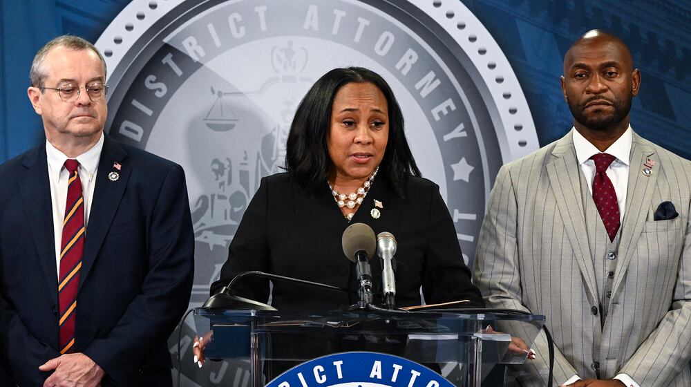 FILE — Fulton County District Attorney Fani Willis holds a press conference to announce the indictment of former President Donald Trump and others, in Atlanta on Aug. 14, 2023. Fani Willis, center, is accused of having a romantic relationship with Nathan Wade, right, a special prosecutor she had hired. (Kenny Holston/The New York Times)