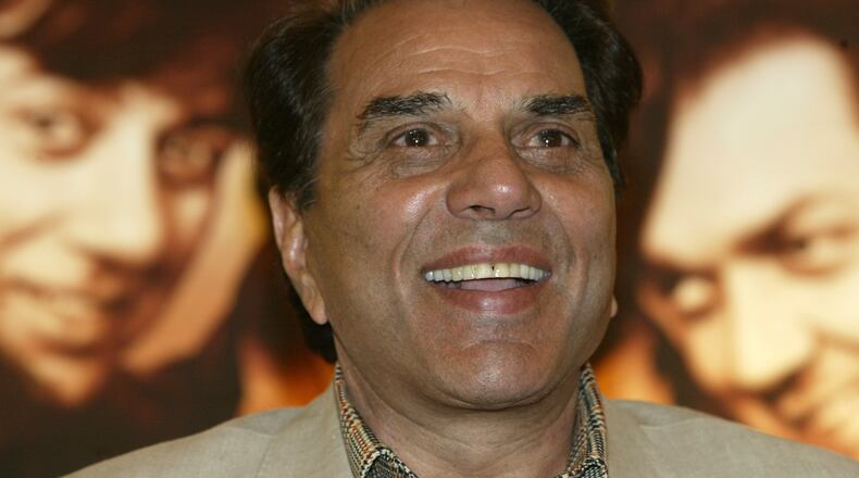 FILE - Bollywood actor and Indian lawmaker Dharmendra reacts during a promotional press conference of his latest film "Apne" in Calcutta, India, Monday, June 25, 2007. (AP Photo/Bikas Das, File)