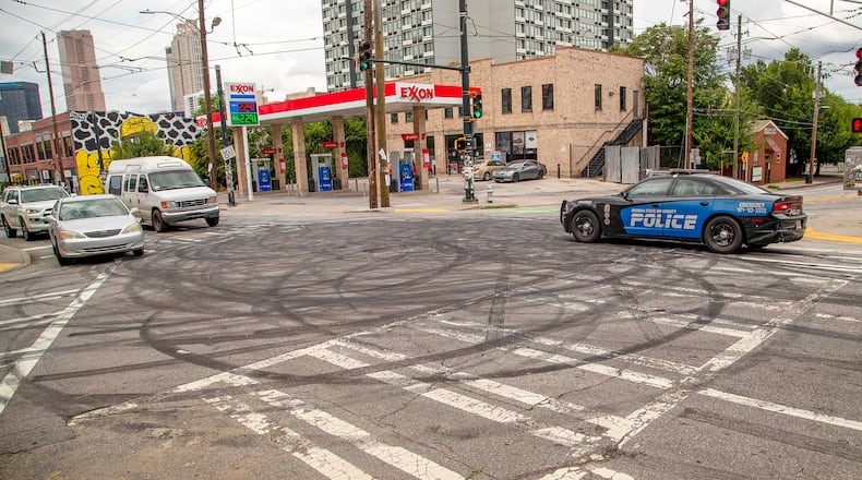 A Georgia State University patrol car rolls through the intersection of Edgewood Avenue SE and Jackson Street SE, where tire doughnuts can be seen in Atlanta’s Sweet Auburn District community on Monday, July 6, 2020. (ALYSSA POINTER / Alyssa.Pointer@AJC.com)