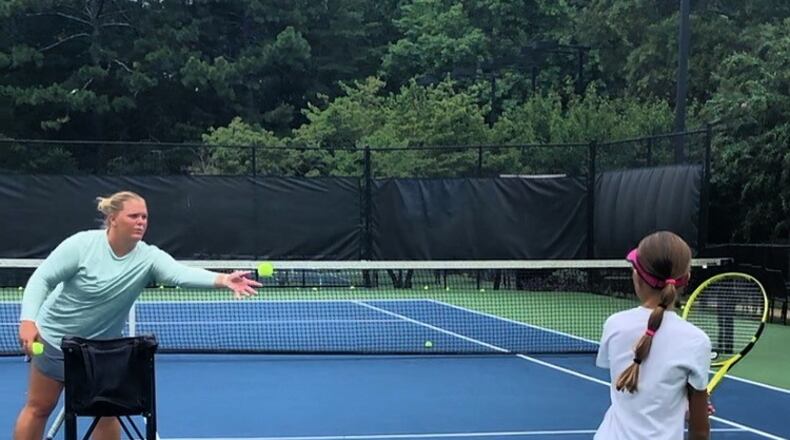 Coach Mel, as Melanie Oudin goes by now, works on a pupil's backhand. (Photo courtesy Melanie Oudin)