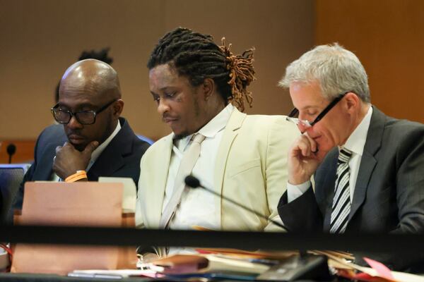 Atlanta rapper Young Thug (center), whose real name is Jeffery Williams, sits next to his defense attorneys Keith Adams (left) and Brian Steel during the YSL trial. The YSL trial occupied much of Adams and Steel's time, meaning other clients on trial and some motions were postponed during the YSL trial, which was the longest in state history. (Jason Getz/AJC)