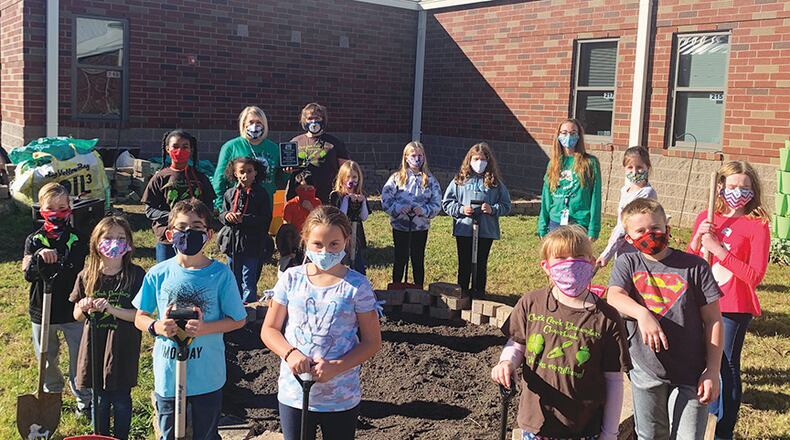 Clark Creek Elementary School STEM Academy has earned the third annual Cherokee County Farm to School Golden Shovel Award!  The Farm to School organization, which is made up of Cherokee County Farm Bureau members, educators and community volunteers, presents the award annually to the best overall school garden and accompanying educational program. Pictured: Clark Creek ES STEM Academy Principal Joey Moss, left, and teacher Karen Garland celebrate the honor with students.