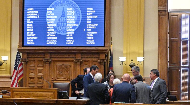 November 9, 2021 Atlanta - Lieutenant Governor Geoff Duncan and lawmakers confer as they start debating and voting on redistricting maps in the Senate Chambers during a special session at the Georgia State Capitol in Atlanta on Tuesday, November 9, 2021. The hearing was a step toward votes on new political maps for the state House, state Senate and Congress during a once-a-decade redistricting session of the General Assembly. The Senate plans to vote on new maps Tuesday, and the House Redistricting Committee could advance its proposal as well. (Hyosub Shin / Hyosub.Shin@ajc.com)