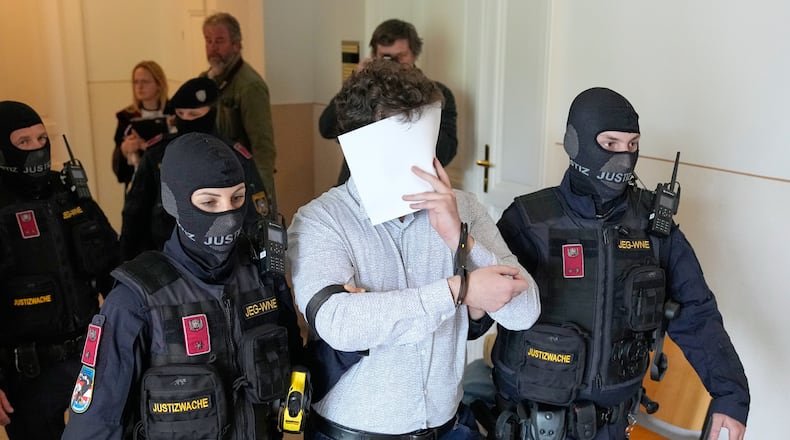 FILE - Defendant Beran A. is returned to the courtroom in the District Court in Wiener Neustadt, Austria, where he stands trial for plotting to carry out an attack on one of superstar singer Taylor Swift's concerts in Vienna in August 2024 and pledging allegiance to the Islamic State group, April 28, 2026. (AP Photo/Matthias Schrader, File)