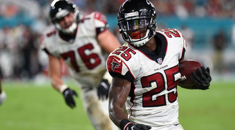 Atlanta Falcons running back Brian Hill (25) runs for a gain during a Thursday, Aug. 10, 2017, week 1 NFL pre-season football game in Miami Gardens, Fla. The Miami Dolphins defeated the Falcons 23 - 20. (Al Messerschmidt via AP)