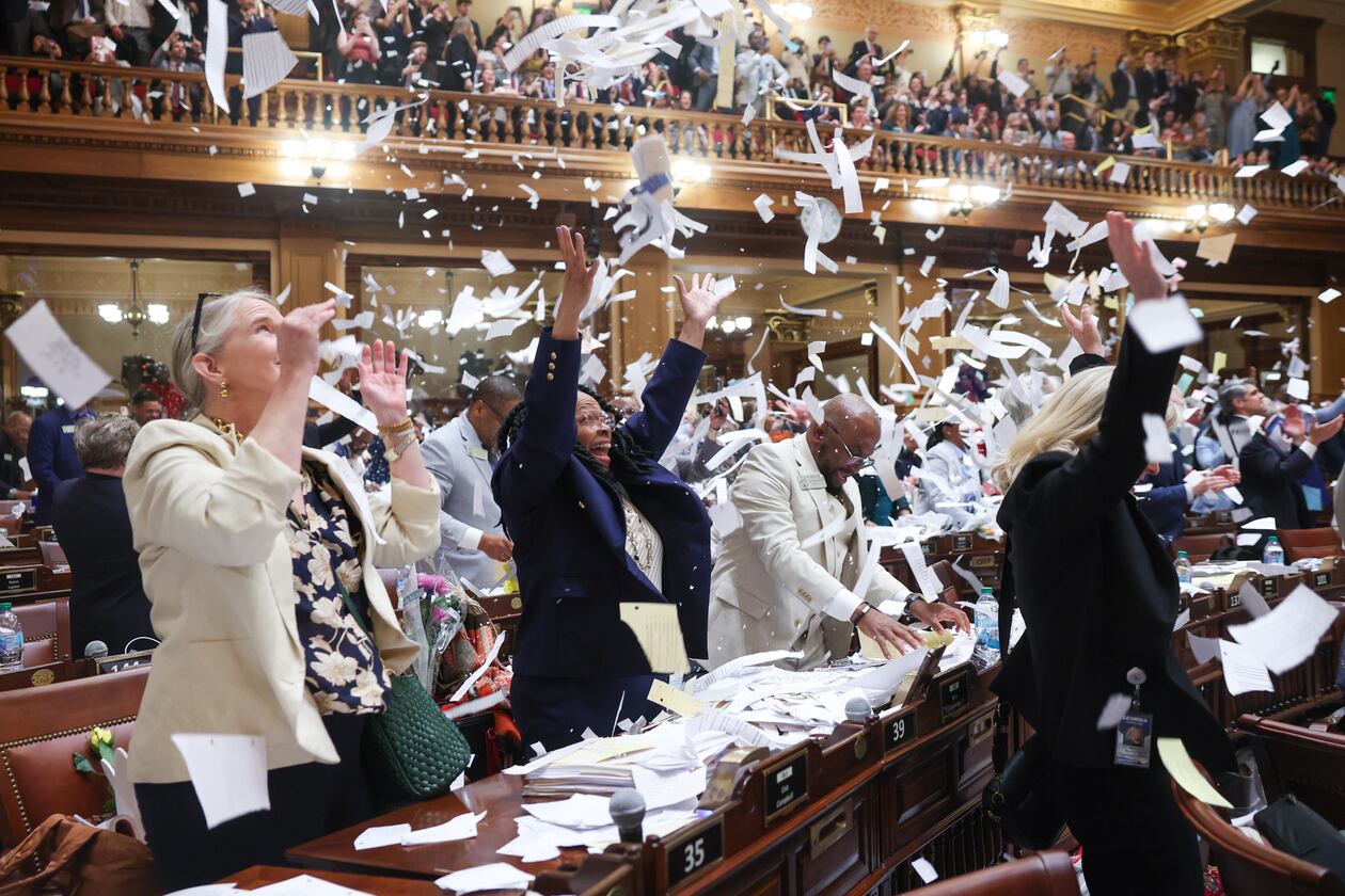 Lawmakers toss papers when the session is called to a close at the House of Representatives on Sine Die, the last day of the legislative session, at the Capitol in Atlanta on April 2, 2026. (Arvin Temkar/AJC)