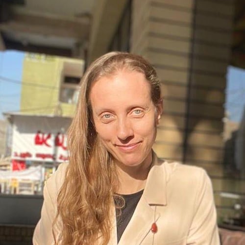 U.S. journalist Shelly Kittleson poses for a cellphone photo in a cafe in Baghdad, Iraq, March 25, 2025. (AP Photo)