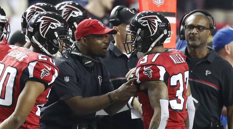 Atlanta Falcons secondary coach Marquand Manuel talks to safety Ricardo Allen (37) during an NFC Championship NFL game against the Green Bay Packers on Sunday, January 22, 2017. The Falcons defeated the Packers 44-21. (Kevin Terrell via AP)