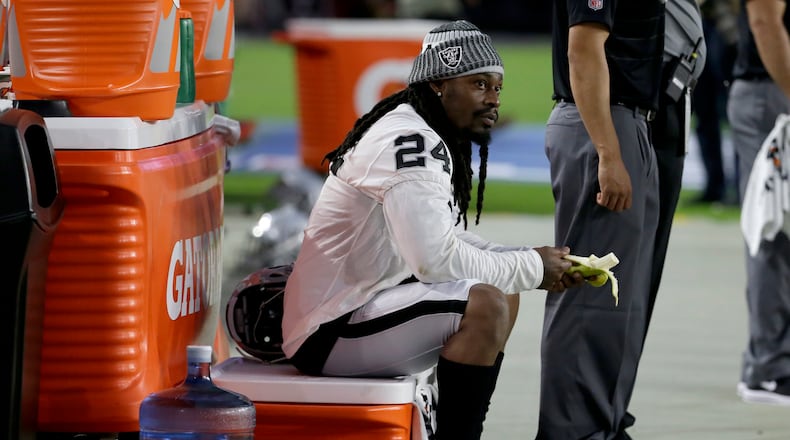 Oakland Raiders running back Marshawn Lynch (24) sits during the national anthem prior to an NFL preseason football game against the Arizona Cardinals, Saturday, Aug. 12, 2017, in Glendale, Ariz. (AP Photo/Rick Scuteri)