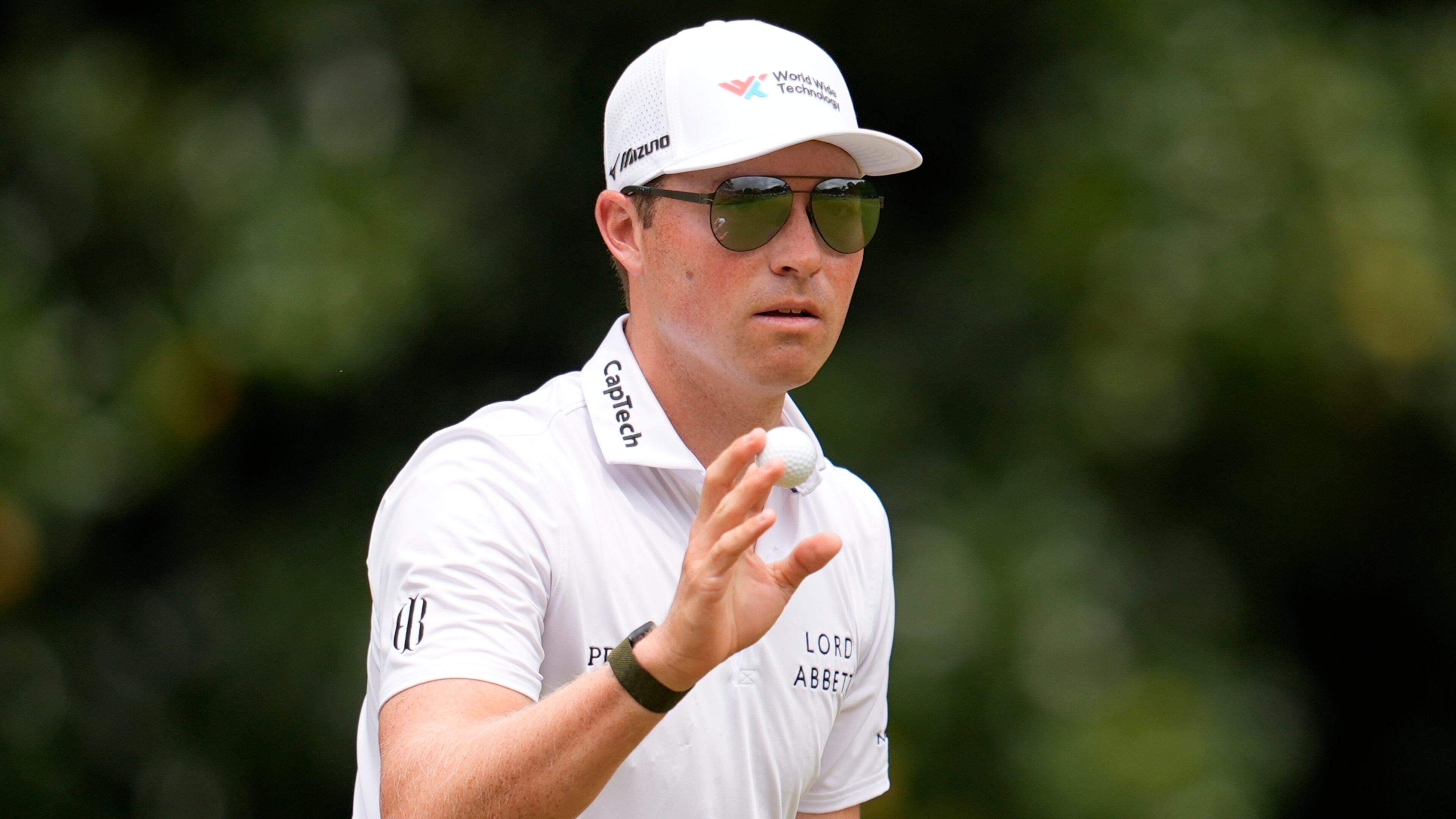 Ben Griffin waves to spectaots on the second green during the third round of the Tour Championship golf tournament, Saturday, Aug. 23, 2025, in Atlanta. (AP Photo/Mike Stewart)