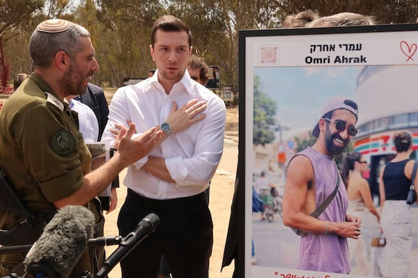 FILE - Leader of France's National Rally (RN) Jordan Bardella, center, listens to Israeli officer Ethan Dana during a visit to a memorial for victims and hostages of the 2023 Hamas attacks, near kibbutz Re'im in southern Israel, Wednesday, March 26, 2025. (Jack Guez/Pool Photo via AP, File)