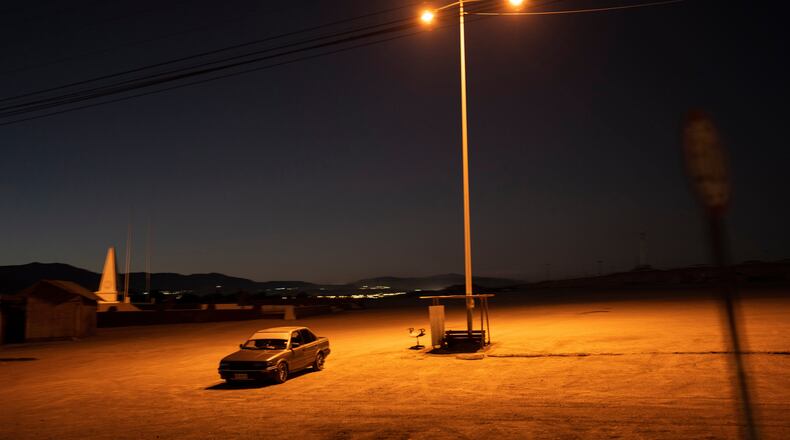 FILE - A driver sits in his car in an empty parking lot in Calama, Chile, Friday, April 14, 2023. (AP Photo/Rodrigo Abd, File)