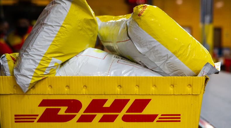 A box of DHL packages is prepared to be shipped on Wednesday, December 16, 2020, at DHL Express in Atlanta. Workers at the shipping center worked to fulfill orders during the holiday rush. CHRISTINA MATACOTTA FOR THE ATLANTA JOURNAL-CONSTITUTION.