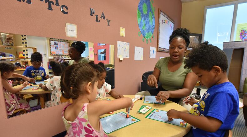 May 3, 2018 Atlanta - Ashton Aiken teaches her preschool students (clockwise from left) Maria Lopez, Annapurna Barakoti and Kiyan Flagg, all 4 years old, at Sheltering Arms International Village Center on Thursday, May 3, 2018. Sheltering Arms International Village Center is one of the few facilities where low-income parents can enjoy quality early childhood education through state subsidies. HYOSUB SHIN / HSHIN@AJC.COM
