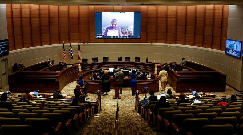 Commissioners and the public listen to a virtual call during a meeting at the Fulton County government building in Atlanta, Georgia, on Wednesday, May 5, 2021. (Rebecca Wright for the Atlanta Journal-Constitution)
