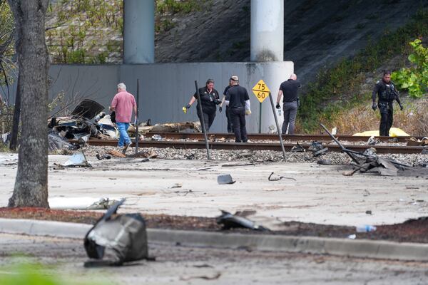 Emergency crew inspect the site of a small plane crash Friday, April 11, 2025 in Boca Raton, Fla. (AP Photo/Marta Lavandier)