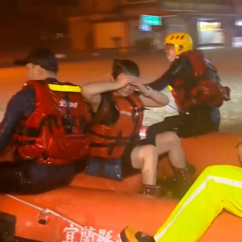 In this image taken from video by Taiwan's EBC, rescuers evacuate stranded people using an inflatable boat in Yilan County in northeastern Taiwan on Tuesday, Nov. 11. 2025. (EBC via AP )
