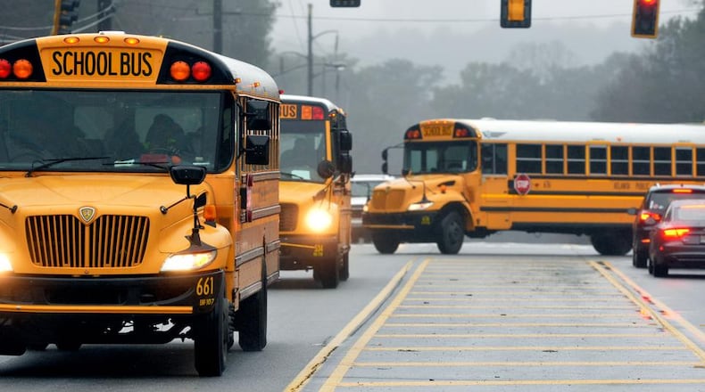 With nearly a dozen school systems starting back on Thursday, the Georgia Department of Transportation urges drivers to exercise caution and maintain a 10-foot buffer around school buses. AJC file photo