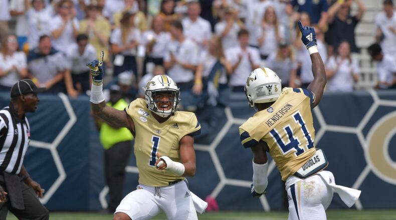Georgia Tech defensive back Juanyeh Thomas (1) and defensive lineman Jaquan Henderson (41) celebrate in the first half. (Hyosub Shin / Hyosub.Shin@ajc.com)