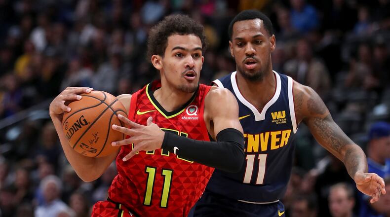 Hawks gaurd Trae Young drives to the basket against the Nuggets' Monte Morris in the first quarter Tuesday, Nov. 15, 2019, at the Pepsi Center in Denver.