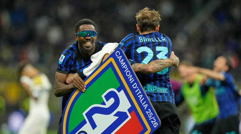 Inter Milan's Marcus Thuram, left, and Inter Milan's Nicolo Barella celebrate their victory at the Serie A soccer match between Inter Milan and Parma, in Milan, Italy, Sunday, May 3, 2026. (AP Photo/Luca Bruno)