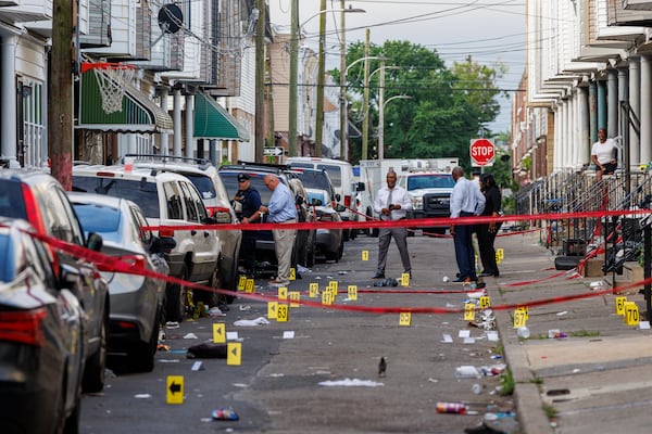 Crime scene evidence markers line a street in Philadelphia after an overnight shooting, early Monday, July 7, 2025. (Alejandro A. Alvarez/The Philadelphia Inquirer via AP)