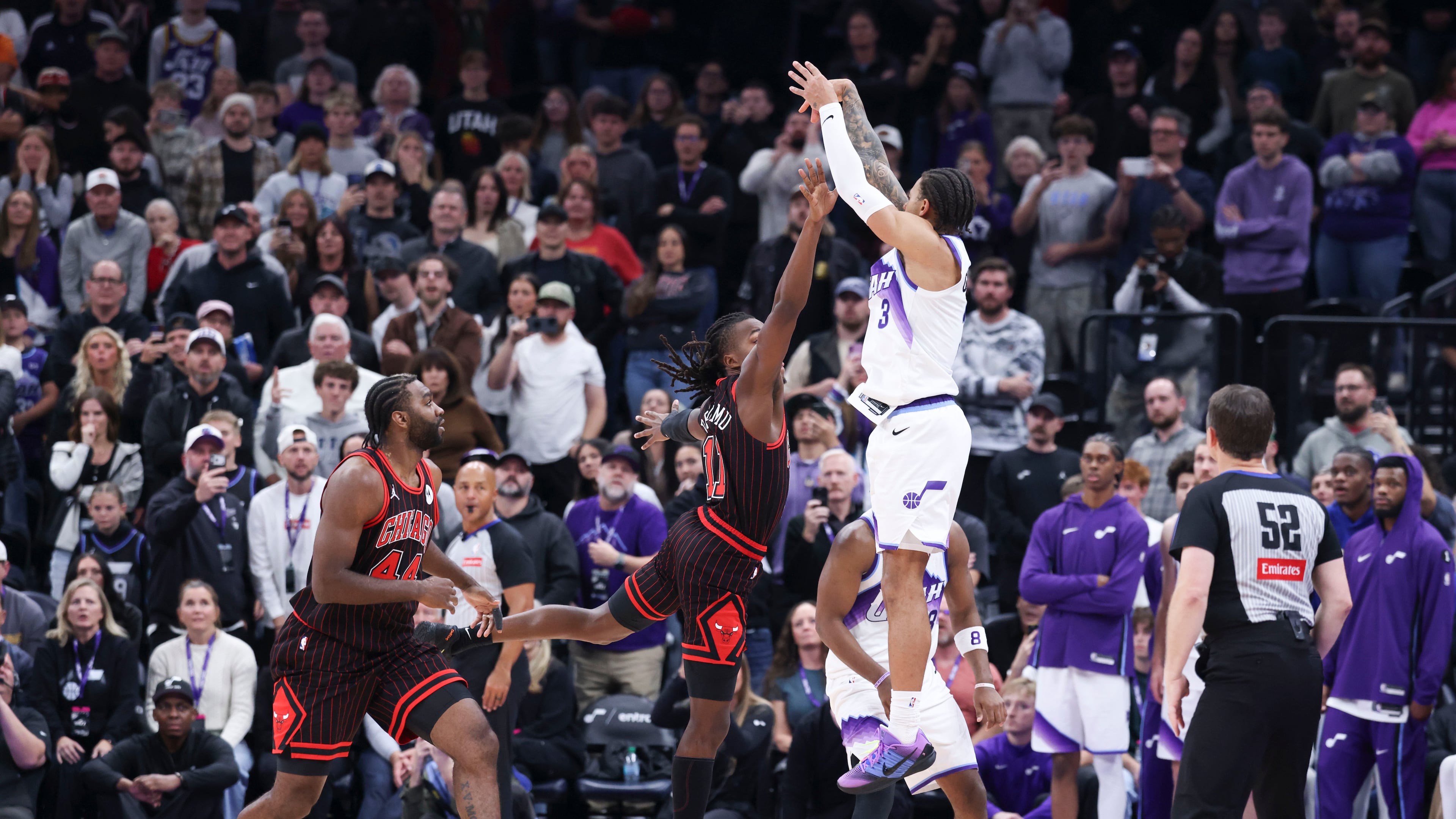 Utah Jazz guard Keyonte George (3) makes a three-point basket over Chicago Bulls guard Ayo Dosunmu to take the lead in the last seconds of the second overtime of an NBA basketball game, Sunday, Nov. 16, 2025, in Salt Lake City. (AP Photo/Rob Gray)