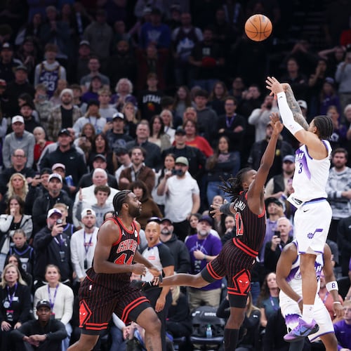 Utah Jazz guard Keyonte George (3) makes a three-point basket over Chicago Bulls guard Ayo Dosunmu to take the lead in the last seconds of the second overtime of an NBA basketball game, Sunday, Nov. 16, 2025, in Salt Lake City. (AP Photo/Rob Gray)