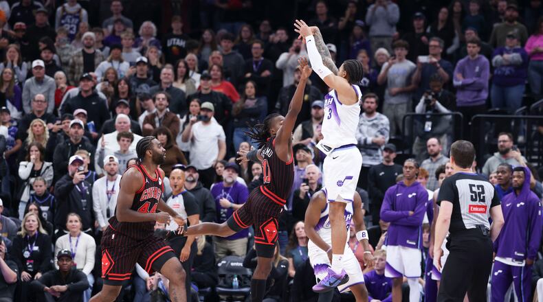 Utah Jazz guard Keyonte George (3) makes a three-point basket over Chicago Bulls guard Ayo Dosunmu to take the lead in the last seconds of the second overtime of an NBA basketball game, Sunday, Nov. 16, 2025, in Salt Lake City. (AP Photo/Rob Gray)