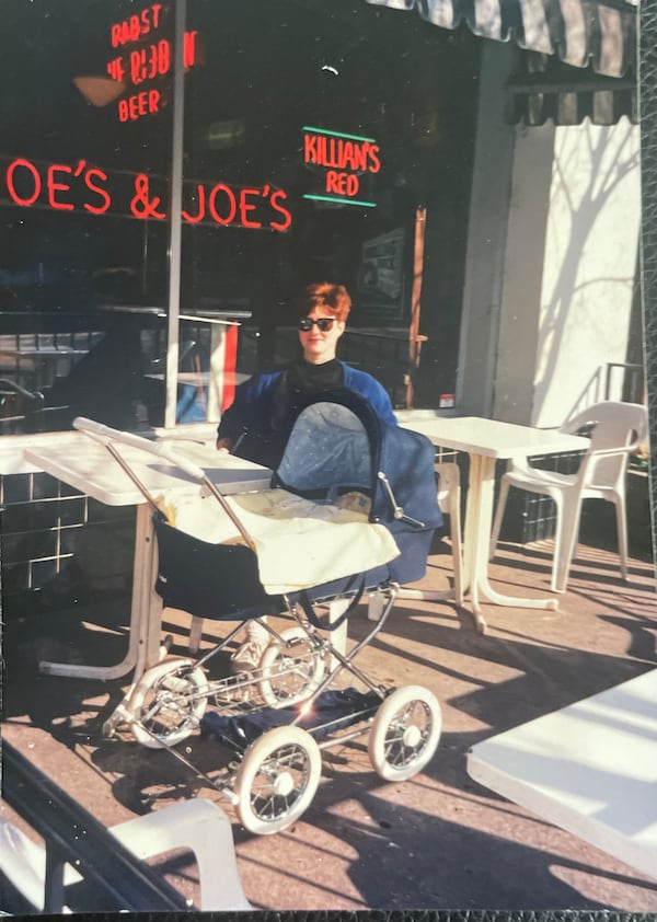 Julie Hodack, the author's wife, ready for a bite at Moe's and Joe's in 1991 with baby Emma, and ready for a quick getaway if the baby wakes up and starts screaming.(Courtesy Bill Torpy)