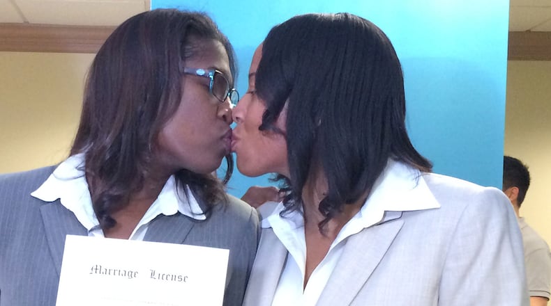 Within minutes of the Supreme Court’s decision legalizing same-sex marriage nationwide, Emma Foulkes (left) and Petrina Bloodworth of Atlanta received the first marriage license for a gay couple in Fulton County.