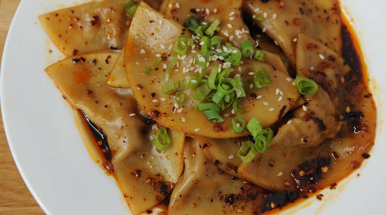 Zhong Style Dumplings at Gu’s Dumplings: Gu’s famous boiled dumplings in secret homemade sweet and spicy Zhong sauce with robust minced garlic, sprinkled with toasted sesame seeds and fresh green onions. CONTRIBUTED BY BECKY STEIN / BECKYSTEINPHOTOGRAPHY.COM