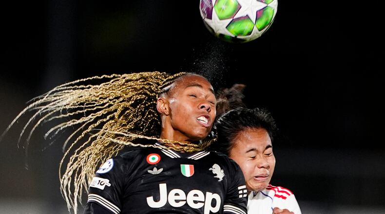 OL Lyonnes's Alice Sombath, right, jumps for the ball with Juventus' Lindsey Thomas during the women's Champions League soccer match between Juventus and OL Lyonnes in Biella, Italy, Wednesday, Nov. 19, 2025. (Fabio Ferrari/LaPresse via AP)