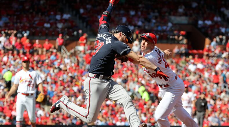 St. Louis Cardinals first baseman Paul Goldschmidt (46) misses the tag on Atlanta Braves third baseman Josh Donaldson (20), during Game 4 of best-of-five National League Division Series at Busch Stadium in St. Louis on Monday, October 7, 2019. (Curtis Compton/ccompton@ajc.com)