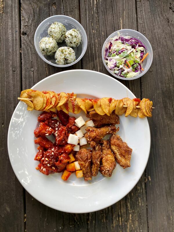 A $29 platter from Seoul Chikin gets you wings, nuggets, two sides and a bite — enough food for two people to share. Wendell Brock for The Atlanta Journal-Constitution