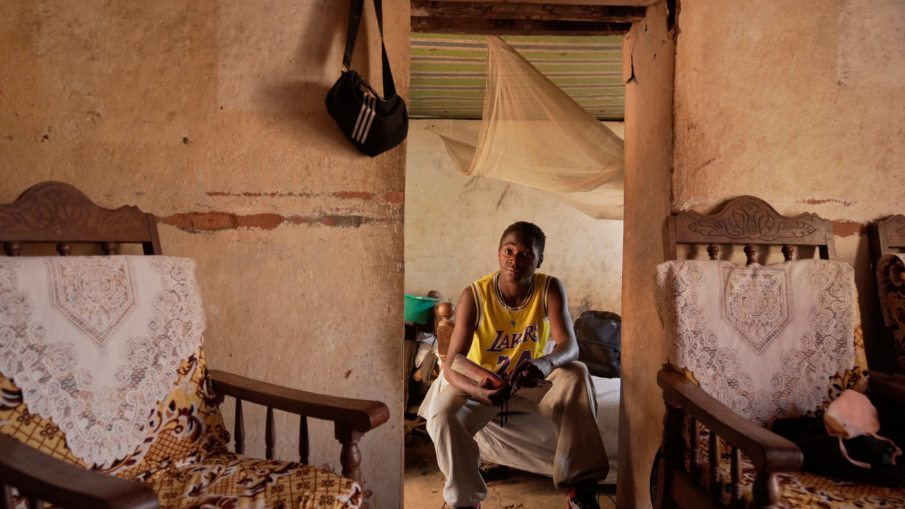 Donah Falia, a 20-year-old student pursuing an accounting course at ABC College, sits inside his aunt's house in Anosimahavelona informal settlement in Antananarivo, Madagascar, Thursday, Oct. 16, 2025. (AP Photo/Brian Inganga)