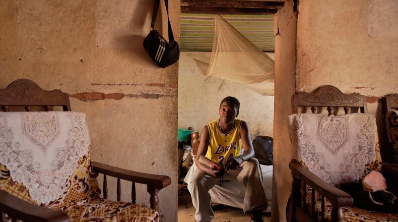 Donah Falia, a 20-year-old student pursuing an accounting course at ABC College, sits inside his aunt's house in Anosimahavelona informal settlement in Antananarivo, Madagascar, Thursday, Oct. 16, 2025. (AP Photo/Brian Inganga)