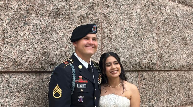 This photo provided by Jen Rickling shows U.S. Army staff sergeant, Matthew Blank, left, and his wife, Annie Ramos, posing for a photo while celebrating their wedding, in March, 2026, in Houston. (Jen Rickling via AP)